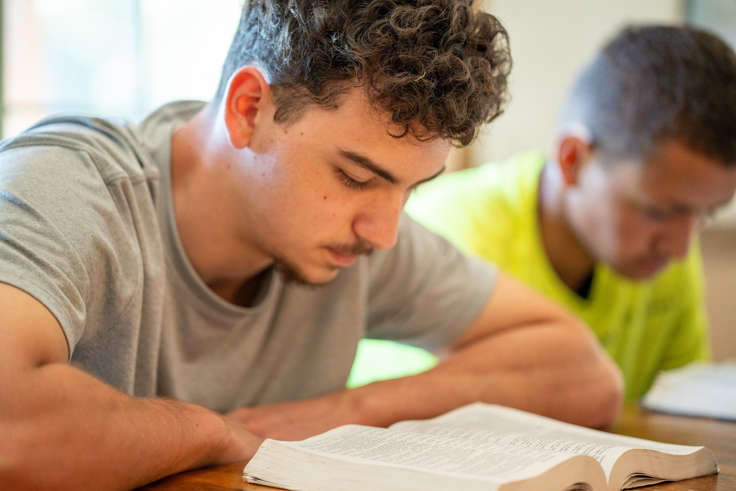 A Future Men student reading and taking notes at a study table
