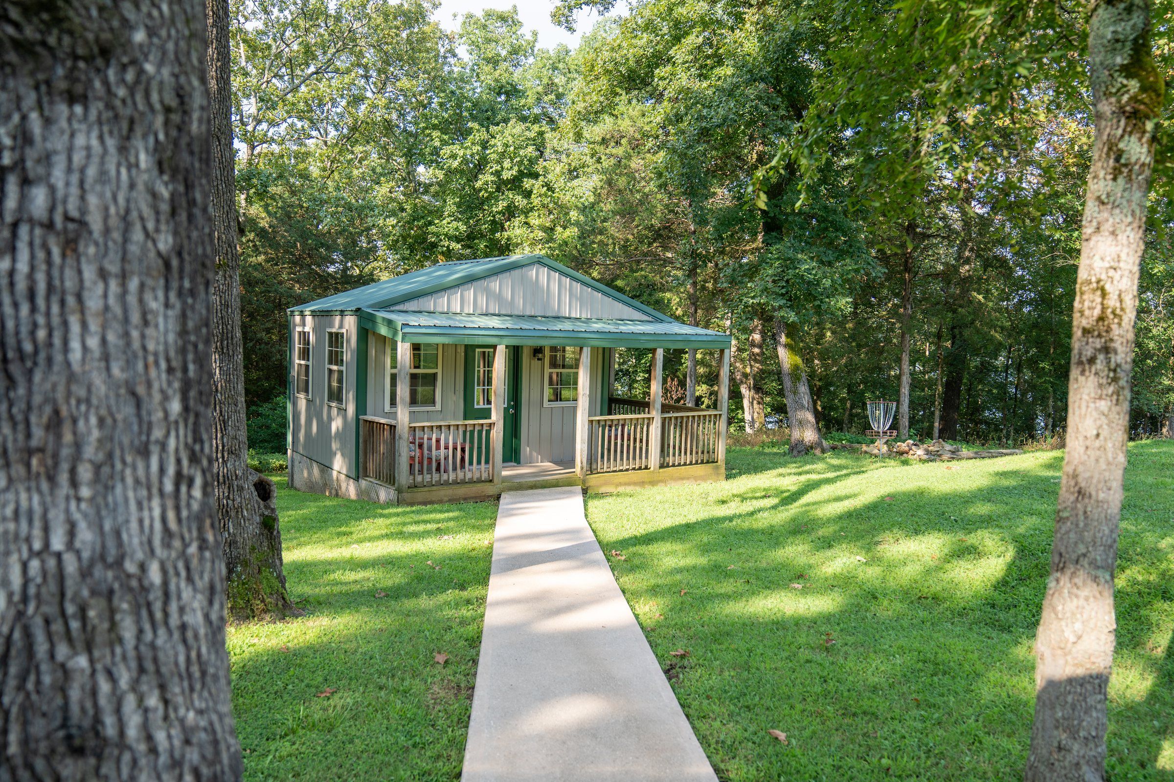 A path leading to a green-roofed cabin on the Future Men campus