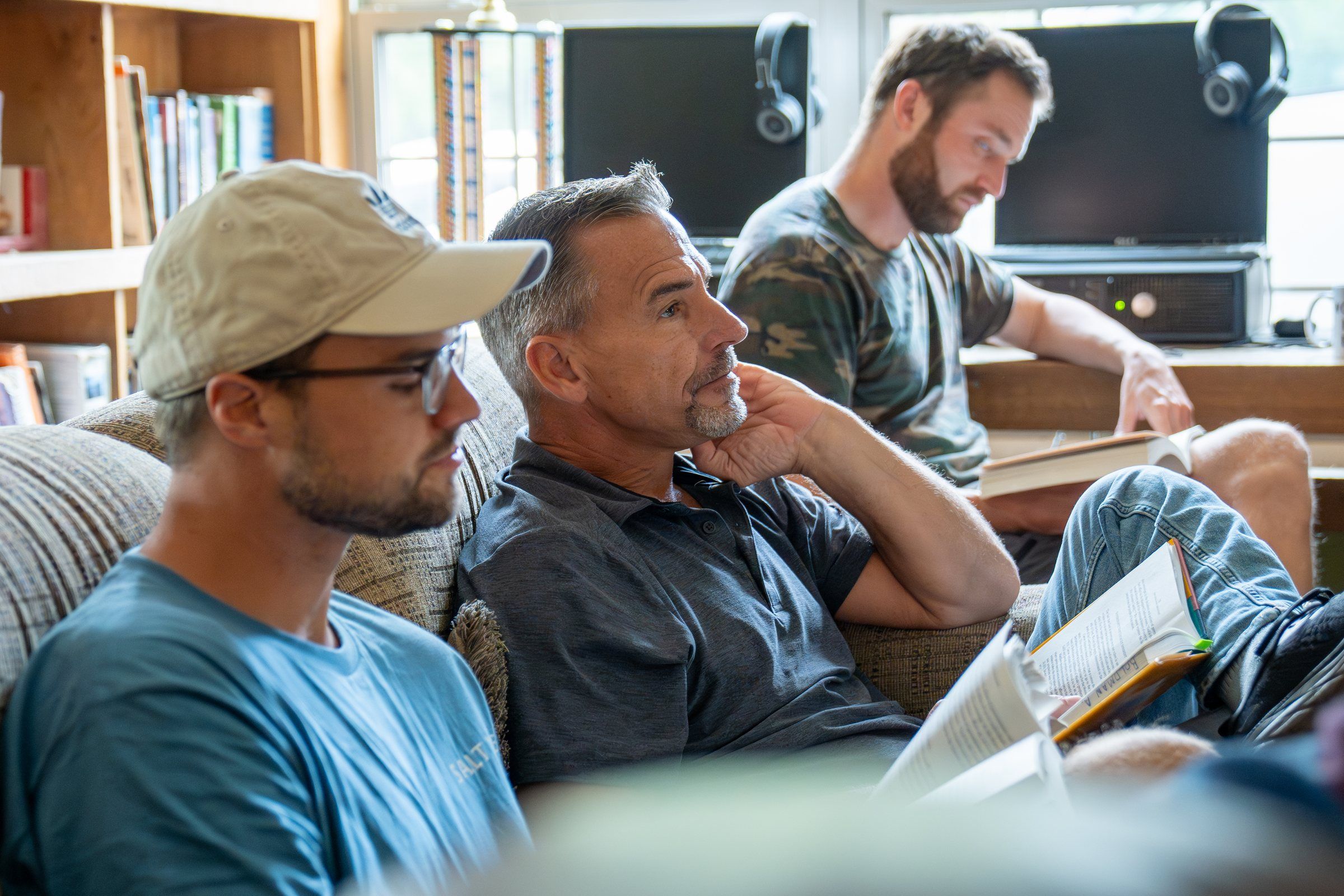 Future Men mentors with open Bibles during a Bible study in the lodge