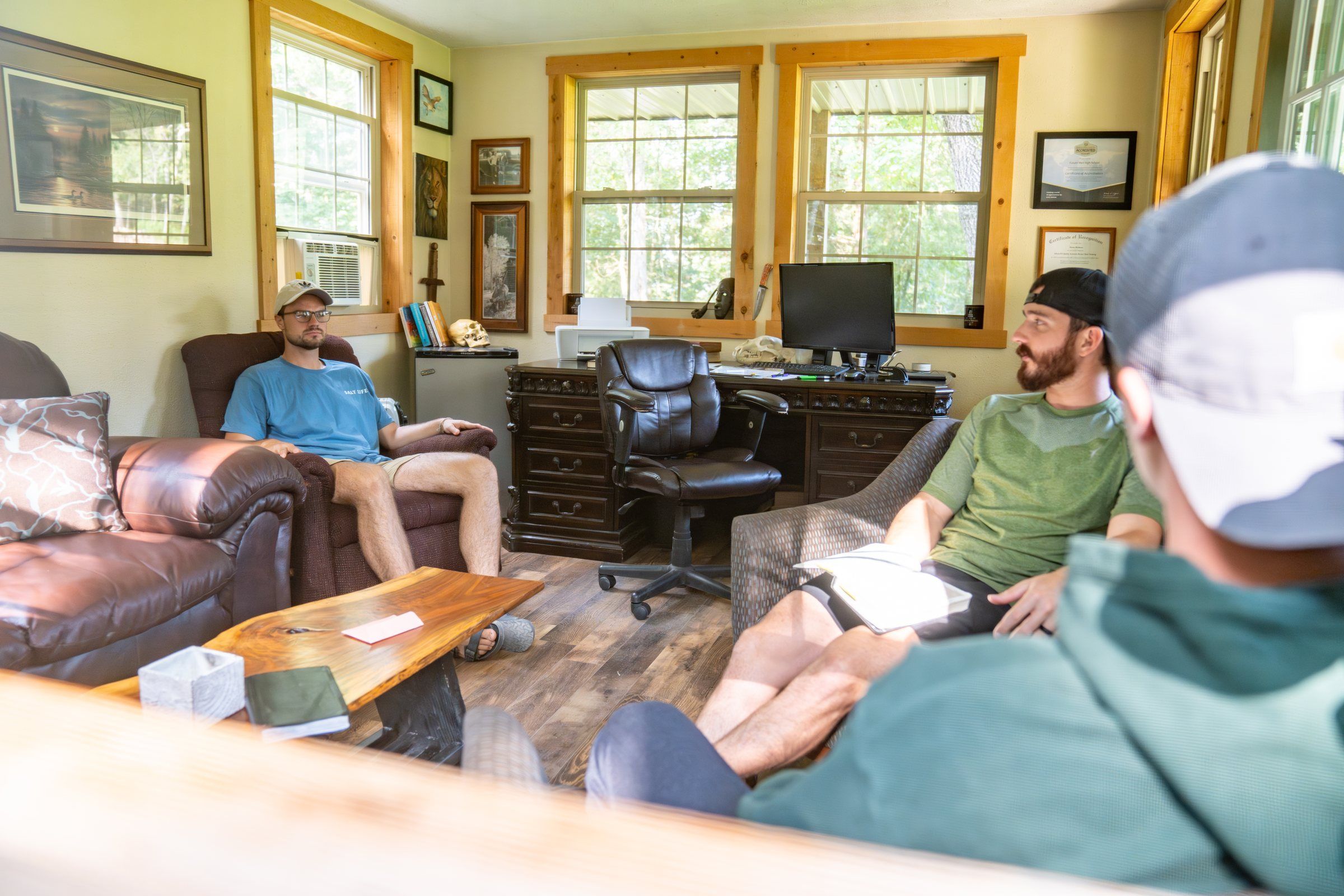 A Future Men staff member meeting with students in the office