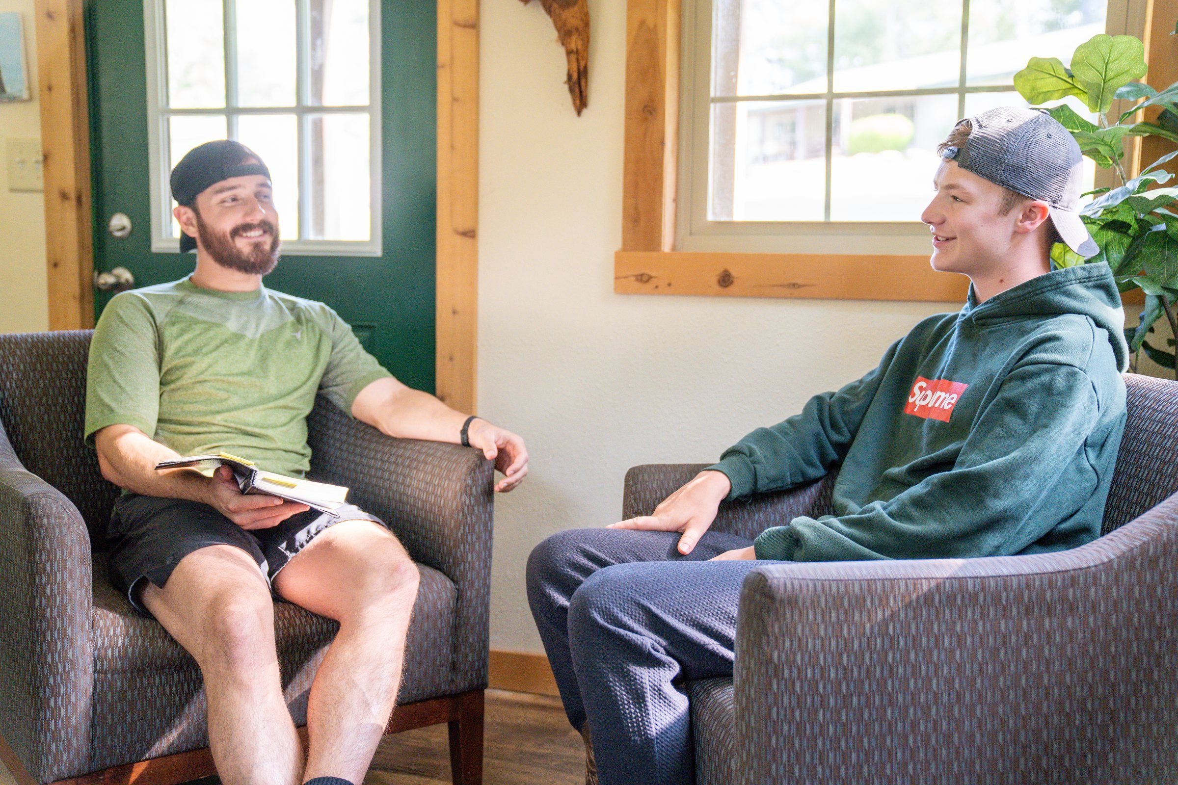A Future Men mentor and a student talking one-on-one in the office