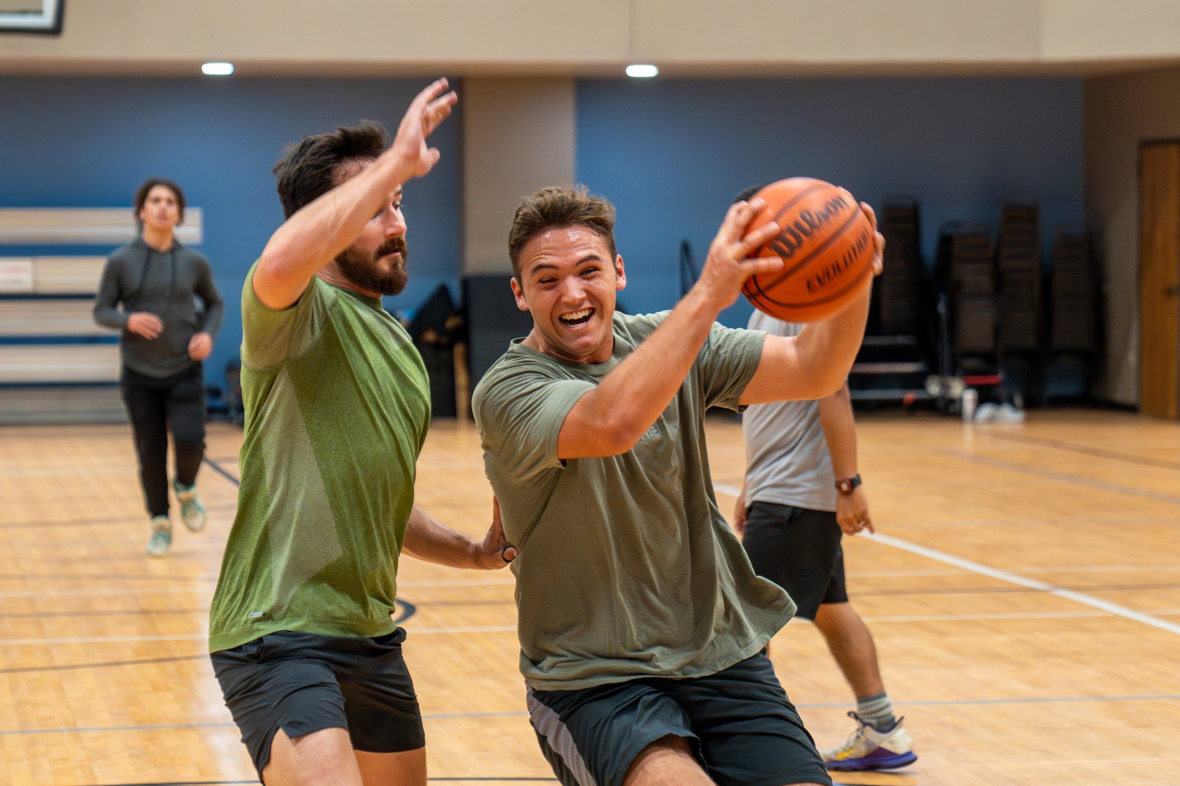 A Future Men student driving to the basket during a pickup basketball game in the gym