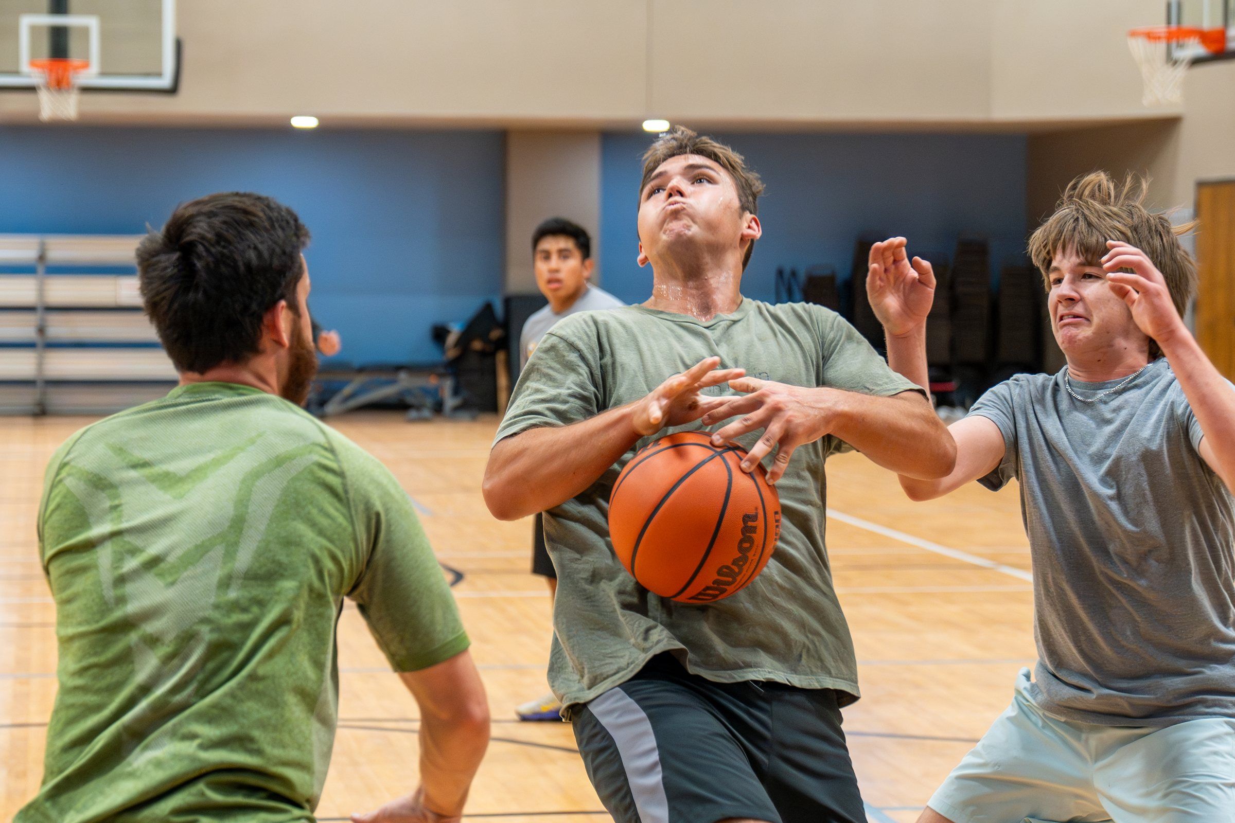 A Future Men student going up for a layup in the indoor gym