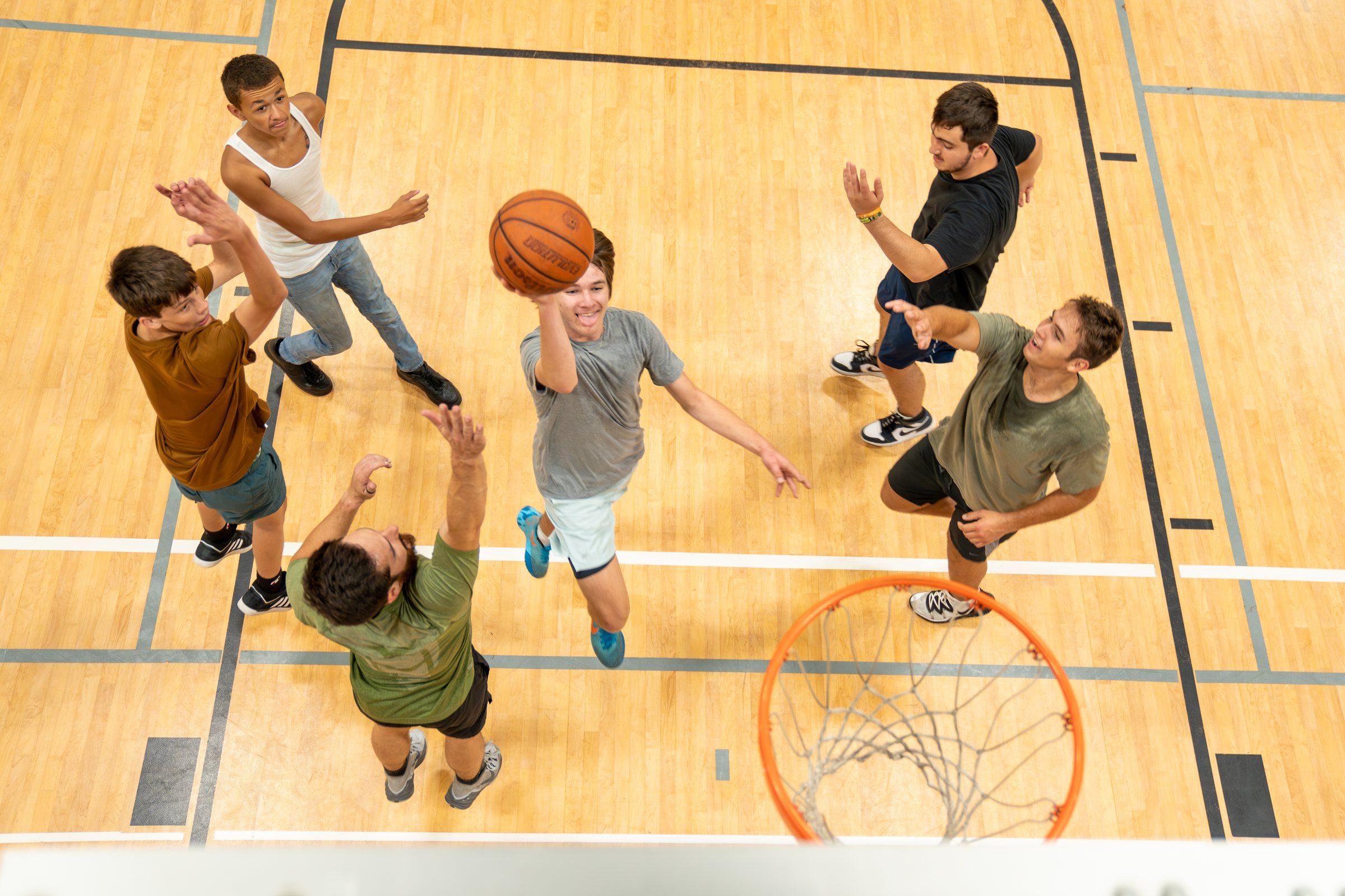 Students playing basketball, seen from above the hoop