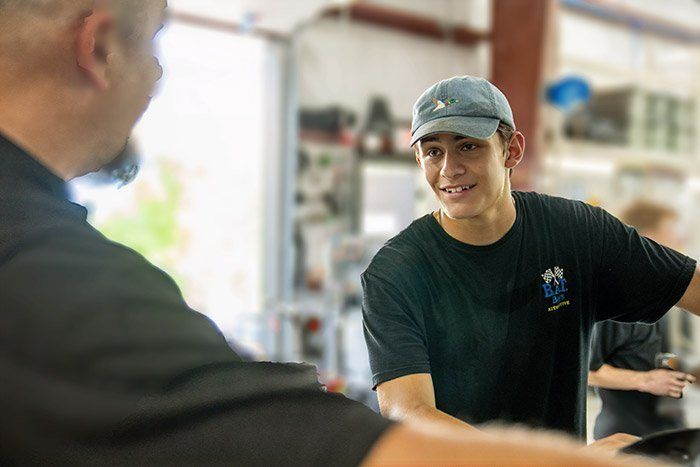 A Future Men apprentice smiling as he takes instruction in a shop